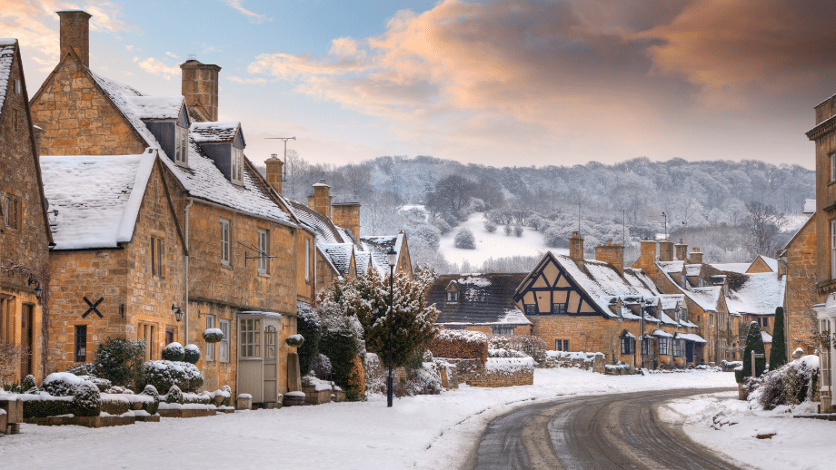 UK residential street, possibly in a small town or village, covered in snow.